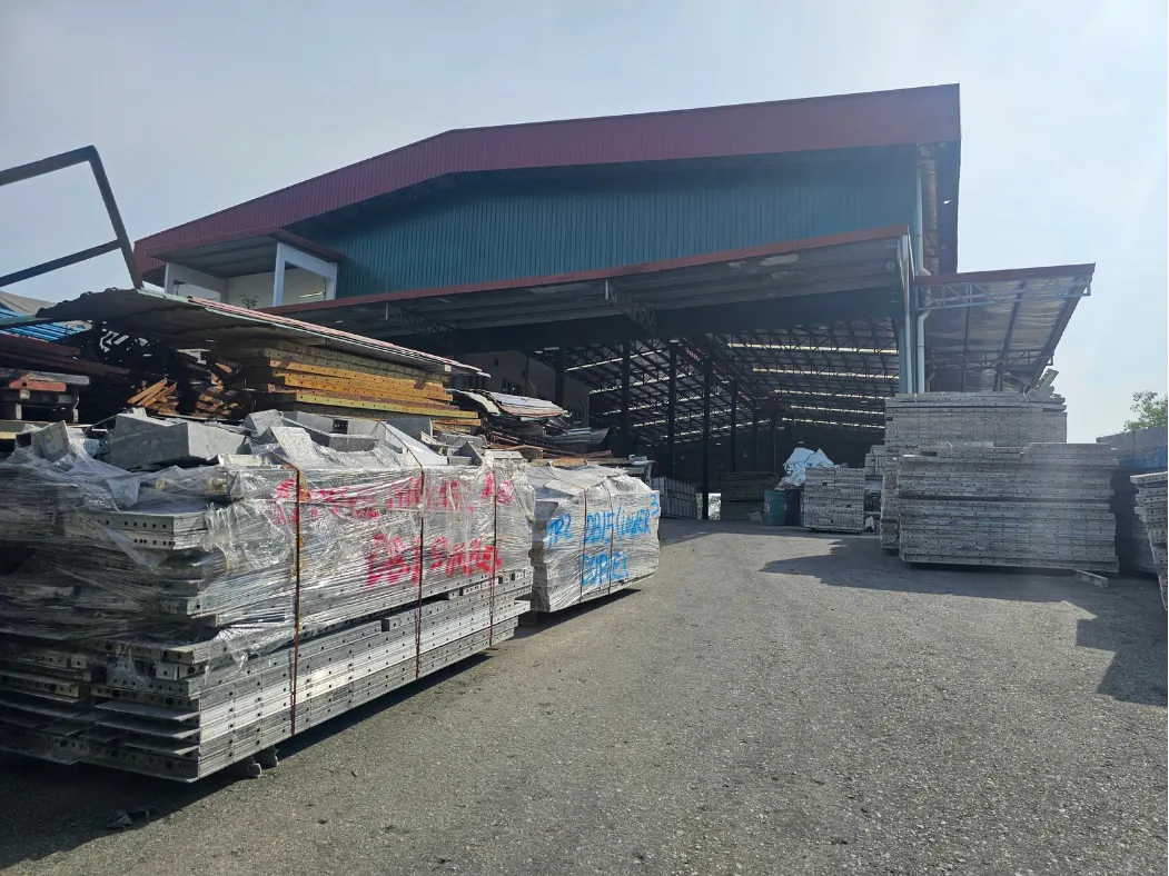 Aluminium formwork and site hardware in the Nilai yard, each bundle tagged to the project it is heading to.